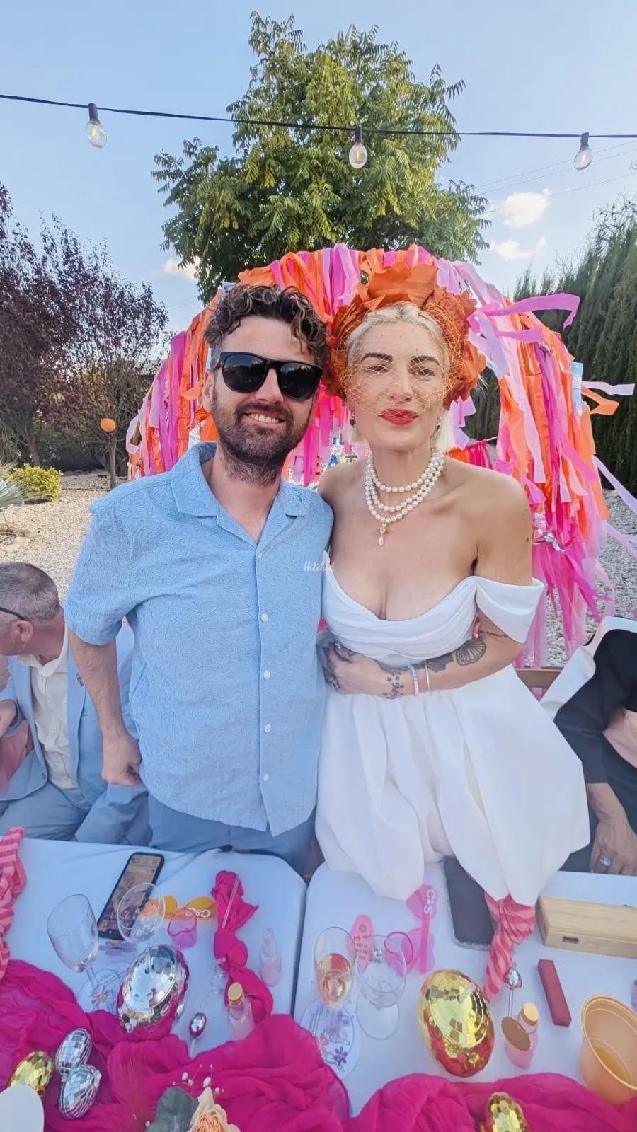 Couple celebrating at a colourful party