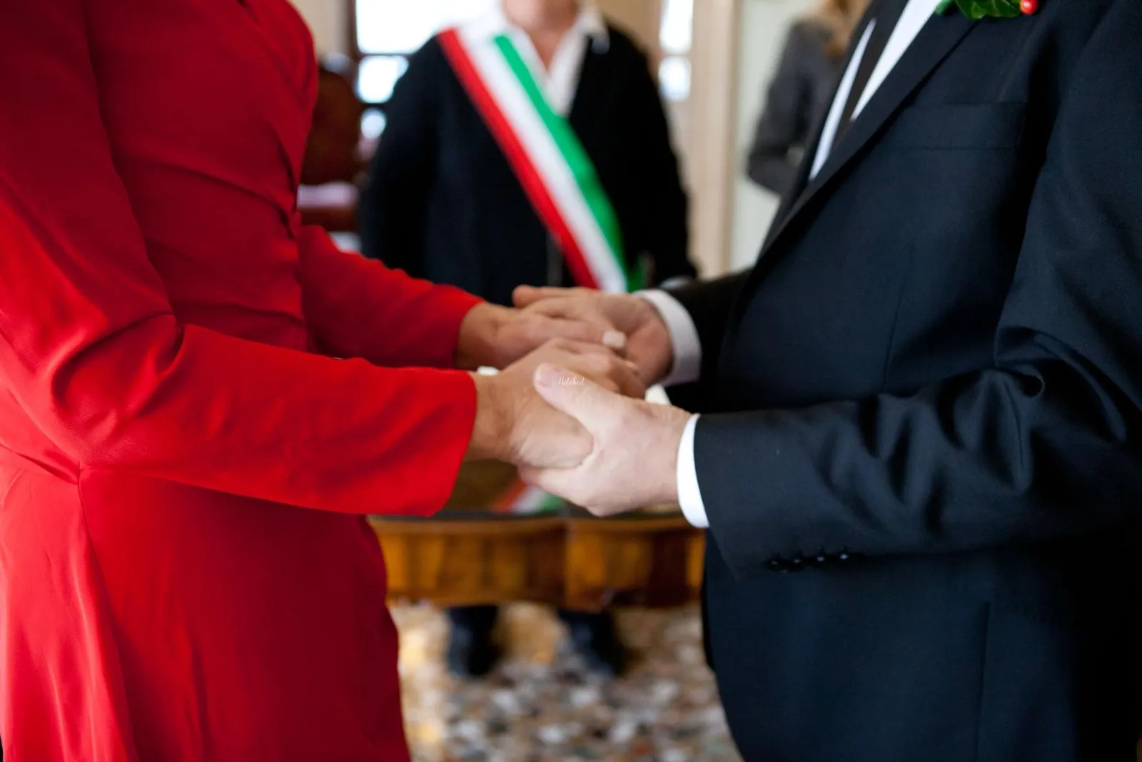 Couple holding hands during the ceremony