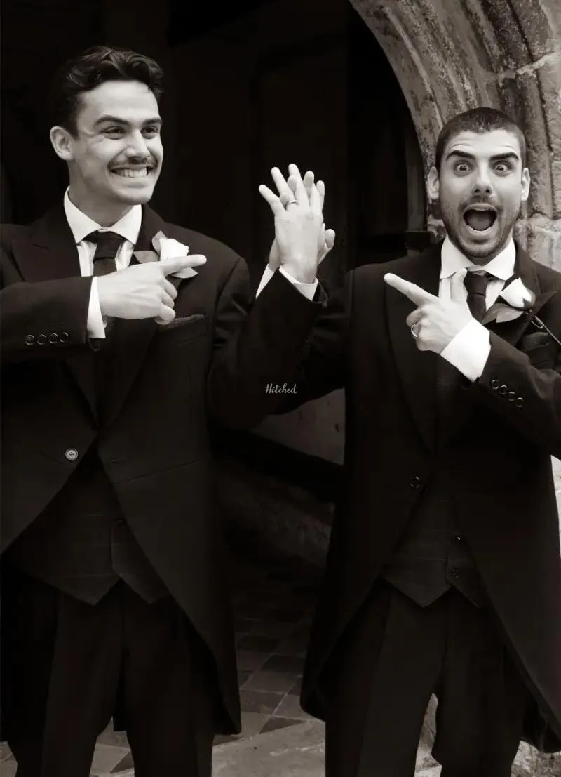 Two grooms celebrating in black and white